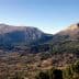 Panoramic view of Tietar Valley featuring mountains and greenery under a clear sky. - Olive Oil Times