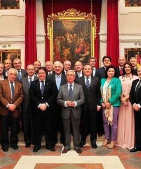 A group of individuals in formal attire posing for a photograph in an indoor setting. - Olive Oil Times
