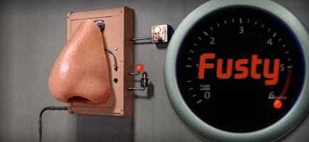 An electronic nose device with a large nose structure and a gauge labeled 'Fusty' on the side. - Olive Oil Times