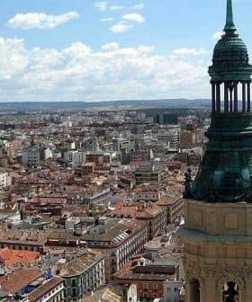 Aerial view of Zaragoza city featuring a prominent tower with a green dome. - Olive Oil Times