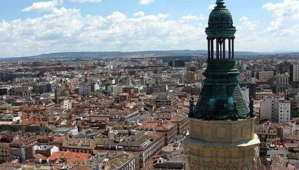 Aerial view of Zaragoza city featuring a prominent tower with a green dome. - Olive Oil Times