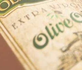 Close-up of an olive oil bottle label featuring the text 'Extra Virgin Olive Oil'. - Olive Oil Times