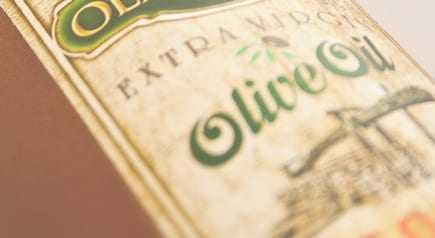 Close-up of an olive oil bottle label featuring the text 'Extra Virgin Olive Oil'. - Olive Oil Times