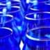 A collection of blue glassware arranged in a row, showcasing their vibrant color and shape. - Olive Oil Times