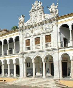 Historic building featuring arched columns and a decorative facade with sculptures and intricate details. - Olive Oil Times