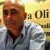 Two men seated at a conference table with a sign that reads 'Terra Olivo'. - Olive Oil Times