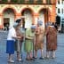Group of elderly women gathered in a plaza in Córdoba, engaged in conversation. - Olive Oil Times
