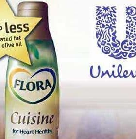 Bottle of Flora Cuisine cooking oil with a label indicating 45% less saturated fat than olive oil. - Olive Oil Times