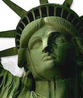 Close-up view of the Statue of Liberty with the Empire State Building in the background. - Olive Oil Times