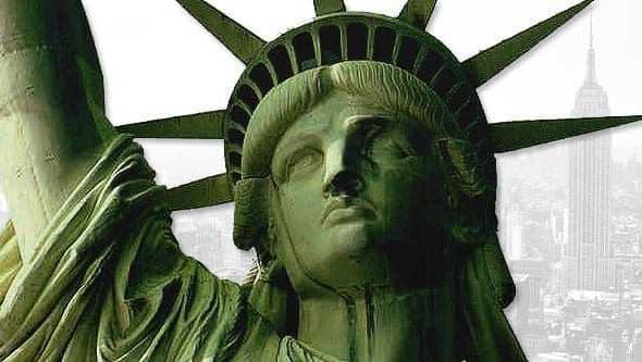Close-up view of the Statue of Liberty with the Empire State Building in the background. - Olive Oil Times