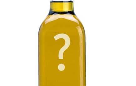Transparent bottle of olive oil featuring a large question mark on the label. - Olive Oil Times