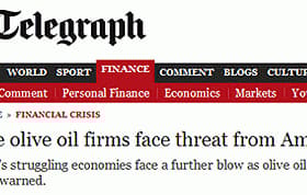 Header of The Telegraph article discussing threats to Eurozone olive oil firms from America. - Olive Oil Times
