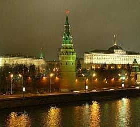 Night view of the Moscow Kremlin with illuminated towers and buildings along the river. - Olive Oil Times