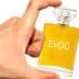 Hand holding a small glass bottle labeled 'EVOO' containing yellow liquid. - Olive Oil Times