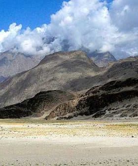 Mountain landscape in Pakistan featuring rocky terrain and clouds in the sky. - Olive Oil Times