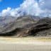 Mountain landscape in Pakistan featuring rocky terrain and clouds in the sky. - Olive Oil Times