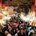 A busy market in Tehran filled with people and various stalls displaying goods. - Olive Oil Times