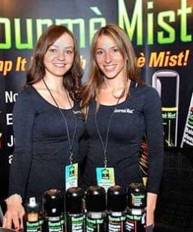 Two women posing with Gourmè Mist products at a promotional event. - Olive Oil Times