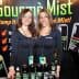 Two women posing with Gourmè Mist products at a promotional event. - Olive Oil Times