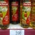 Three bottles of Carbonell olive oil displayed on a store shelf with a price tag below. - Olive Oil Times