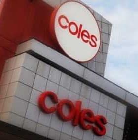 Signage of Coles supermarket featuring the logo and name in red on a building facade. - Olive Oil Times