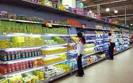 Grocery store aisle displaying a variety of packaged products on shelves. - Olive Oil Times