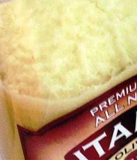 Container of olive oil showing a creamy, thick texture at the top. - Olive Oil Times