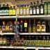 Multiple bottles of olive oil displayed on a grocery store shelf in various sizes and brands. - Olive Oil Times