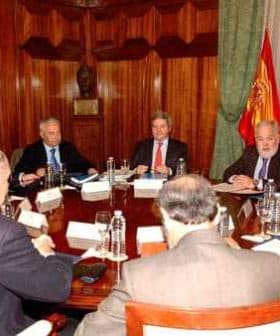Group of officials seated around a large conference table during a meeting. - Olive Oil Times