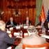 Group of officials seated around a large conference table during a meeting. - Olive Oil Times