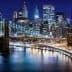 Night view of Brooklyn Bridge with illuminated New York City skyline in the background. - Olive Oil Times