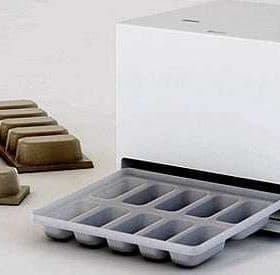 Ice cube tray with a storage container and several ice cube molds beside it. - Olive Oil Times