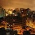 A nighttime view of Lima, Peru, showcasing buildings and city lights under a cloudy sky. - Olive Oil Times