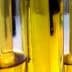Test tubes filled with olive oil arranged in a row, showing the liquid's color and clarity. - Olive Oil Times