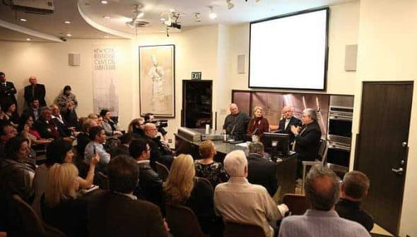 A panel discussion taking place with a seated audience in a well-lit room. - Olive Oil Times