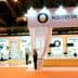 Exhibition booth for Spanish olive oils featuring displays and staff at an event. - Olive Oil Times