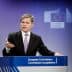A man speaking at a podium during a European Commission press conference with the EU emblem in the background. - Olive Oil Times