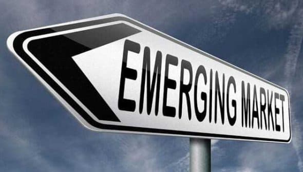 Directional sign indicating 'Emerging Market' with an arrow pointing left. - Olive Oil Times