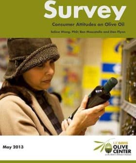 Woman examining a bottle of olive oil while holding a survey document titled 'Consumer Attitudes on Olive Oil'. - Olive Oil Times