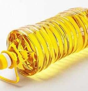 Transparent plastic bottle filled with yellow canola oil, featuring a yellow cap and handle. - Olive Oil Times
