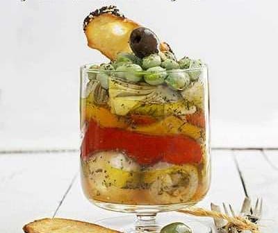 Book cover for 'Cooking Techniques with Olive Oil' featuring a glass container with layered ingredients and herbs. - Olive Oil Times