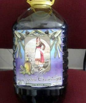 Plastic bottle of extra virgin olive oil with a label featuring a traditional Greek woman. - Olive Oil Times