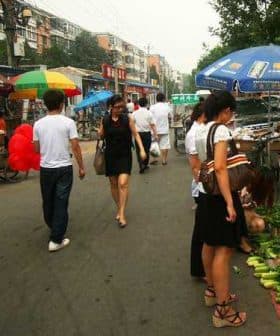 People shopping at a street market with various vegetables displayed on the ground. - Olive Oil Times