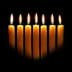 Eight yellow candles arranged in a row, each with a flame, against a dark background. - Olive Oil Times