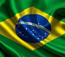 The flag of Brazil featuring green and yellow colors with a blue globe and white stars. - Olive Oil Times