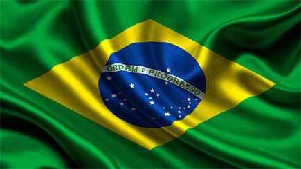 The flag of Brazil featuring green and yellow colors with a blue globe and white stars. - Olive Oil Times