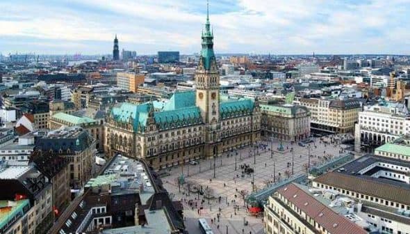 Aerial view of Hamburg City Hall with surrounding buildings and streets in the city. - Olive Oil Times