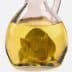 A mouse submerged in a glass bottle filled with yellow liquid, resembling oil. - Olive Oil Times