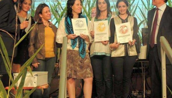 Group of individuals at an award ceremony holding certificates on stage. - Olive Oil Times