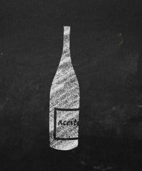 Illustration of a vinegar bottle with the label 'Aceto' on a black background. - Olive Oil Times
